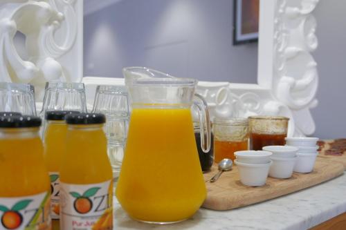 a pitcher of orange juice sitting on a counter at Hôtel Le Golfe Ecolabel EU in Porto Ota