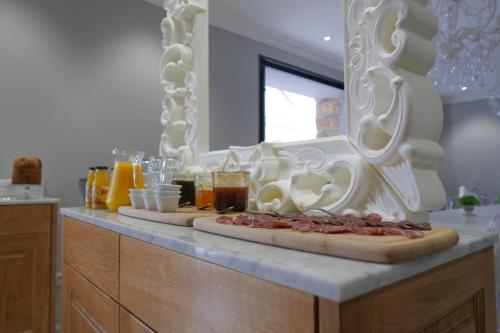 a counter with two pizzas sitting on top at Hôtel Le Golfe Ecolabel EU in Porto Ota