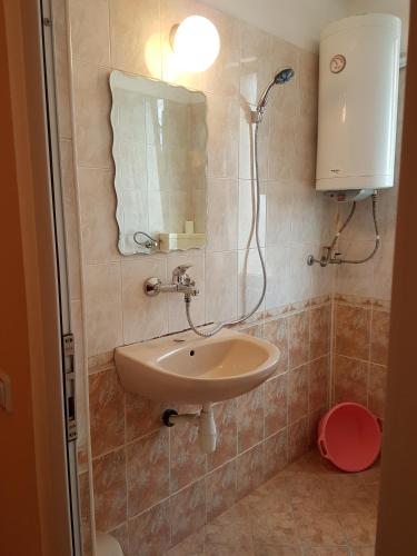 a bathroom with a sink and a mirror at Guest Rooms Denitsa in Obzor