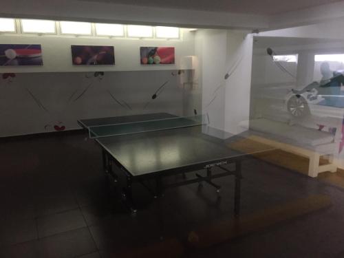 a ping pong table in the middle of a room at Marbella Juan Dolio in Juan Dolio