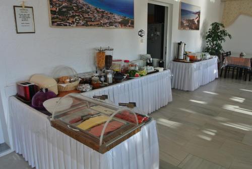 a buffet line with food on it in a room at Kokalakis Hotel in Kefalos