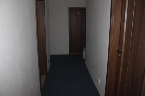 an empty hallway with a room with a door and a carpet at Penzion Vesely in Železný Brod