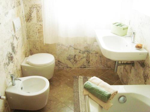 a bathroom with a sink and a toilet and a sink at Residenza Alice 2 - Toscana mare e monti in Camaiore