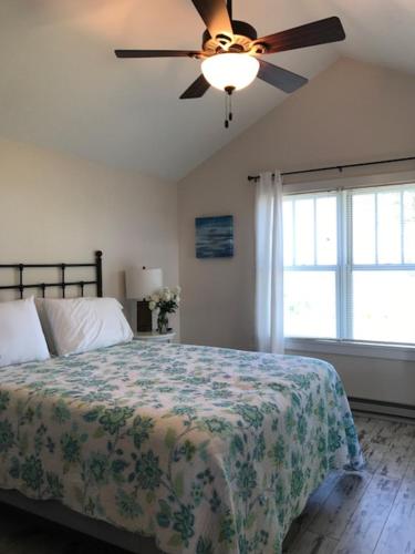 a bedroom with a bed and a ceiling fan at Rainbow Shores in Pulaski