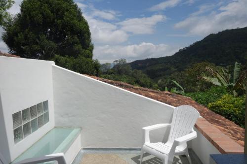 a white chair sitting on the roof of a house at El Romeron Casa de Campo in San Francisco