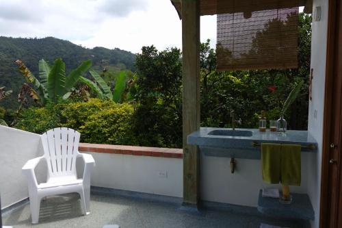 a bathroom with a sink and a white chair at El Romeron Casa de Campo in San Francisco