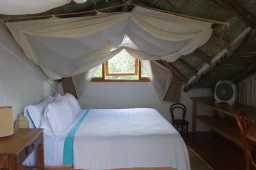 a bedroom with a white bed with a canopy at El Romeron Casa de Campo in San Francisco