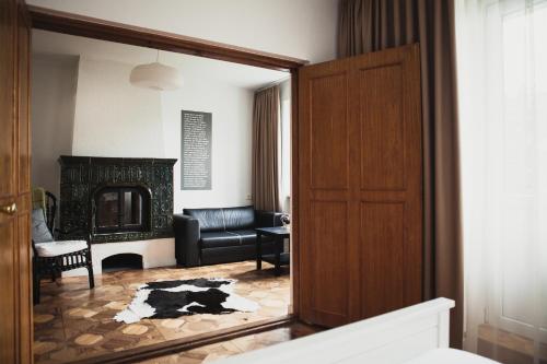 a living room with a door and a couch at SAKÀ Vacation House in Druskininkai