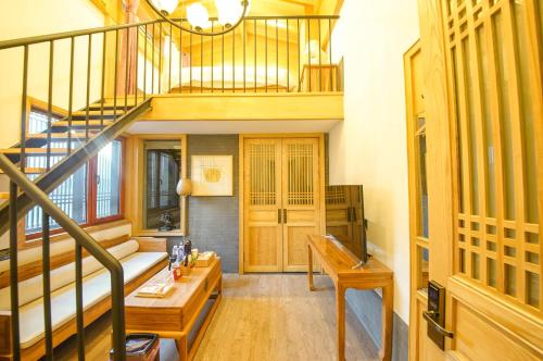 a living room with a staircase and a couch at Pipa Hotel Datong in Datong