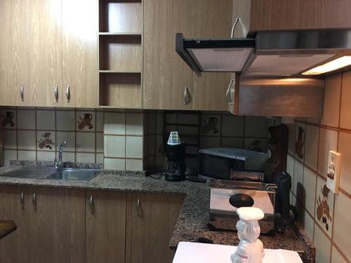 a kitchen with a sink and a counter top at Playa Silgar en Galicia in Sanxenxo