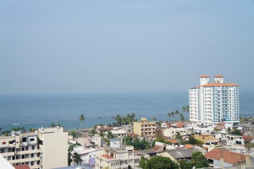 Una ciudad con edificios y el océano al fondo. en Supun Arcade Residency, en Colombo