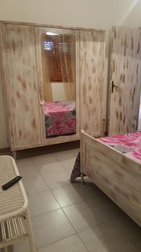 a bedroom with two bunk beds and a mirror at B&B Le Peonie in Badesi