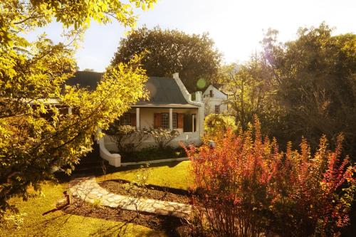 
a house that has a garden in it at Augusta de Mist Country House and Kitchen in Swellendam
