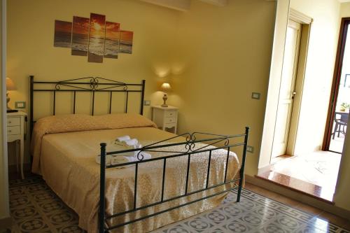 a bedroom with a bed and a large window at La Stella di Keplero in Cannole