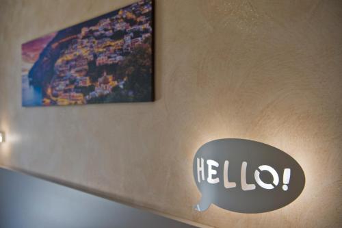 a sign on a wall with a hello sign on it at B&B Casanova in Agerola