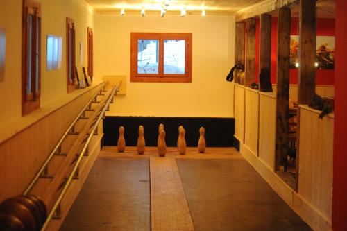 a hallway with a row of vases in a room at Gasthaus Spinas in Bever