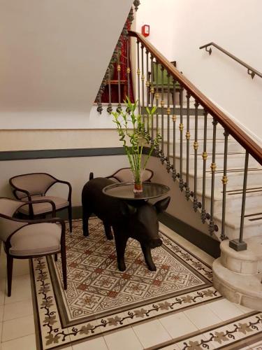 a staircase with a table with a vase on it at Hotel Restaurant Edmond's in Cap d'Ail