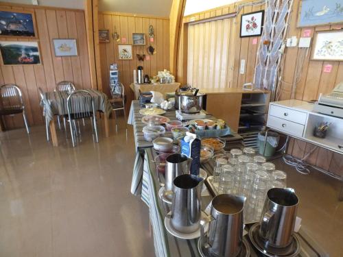 a kitchen with a table with food on it at Bed & Breakfast Pohjan Tuli in Utsjoki