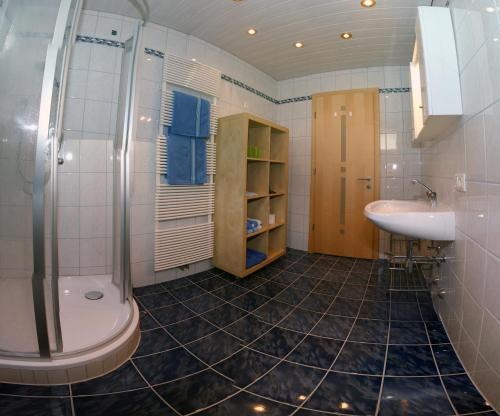 a bathroom with a sink and a shower and a toilet at Apartment Hörhager in Mayrhofen