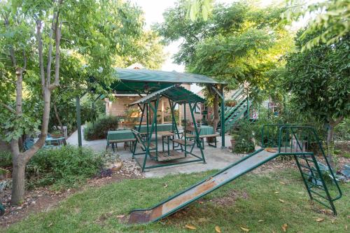 a playground with a slide and a gazebo at Leyad Hashmura Lodging in Yesod Hamaala