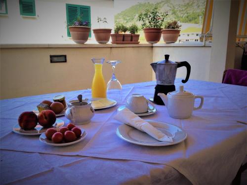 a table with a blue table cloth with fruit on it at Bed and Breakfast BLUE in BLUE in Komiža