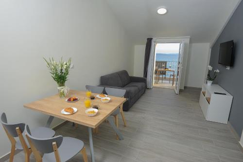 a living room with a table and a couch at Seaside Luxury Suites in Podstrana
