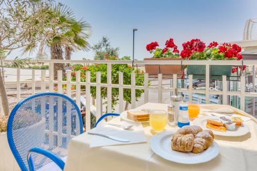 a white table with food and drinks on it at Hotel Garni' Serena in Caorle