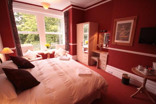 a bedroom with a large bed and a window at The Dales in Harrogate