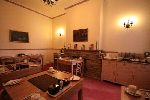 a dining room with tables and chairs in a room at The Dales in Harrogate