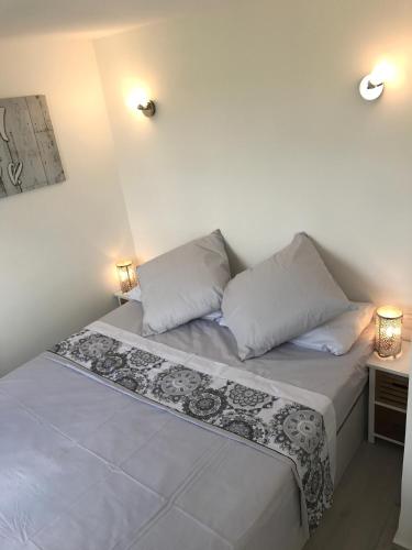 a small bedroom with two beds and a night stand at Buenavista Apartment in Sitges