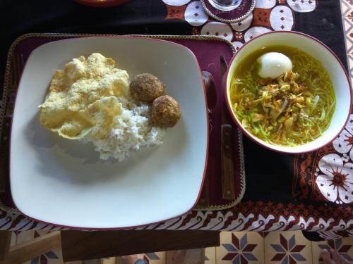 a plate of food with rice and a bowl of soup at Manggis Garden Dive Resort in Candidasa