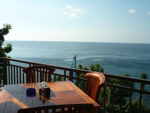 a table on a balcony with a view of the ocean at Shankara Parada Villas in Amed