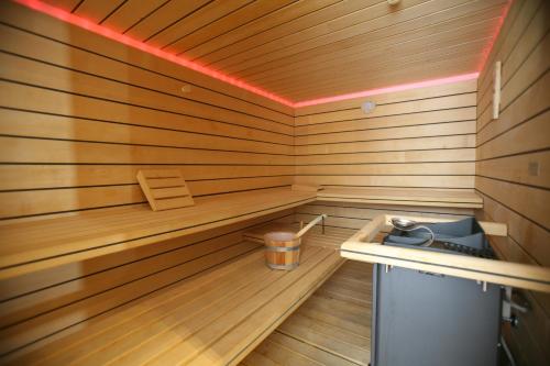 a wooden sauna with a trash can in it at Cristal Palace Hotel in Madonna di Campiglio