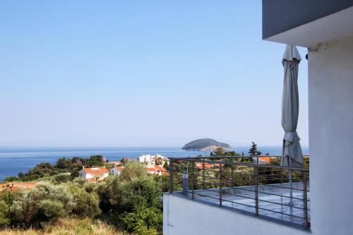a balcony of a house with a view of the ocean at Villa NK in Paleo Tsifliki
