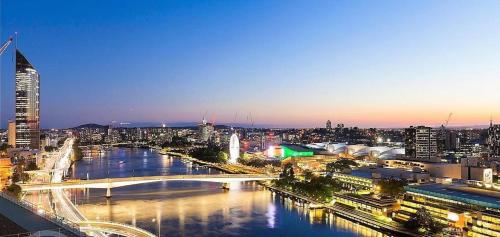 a view of a city with a bridge over a river at S&P Apartments - Tank St in Brisbane
