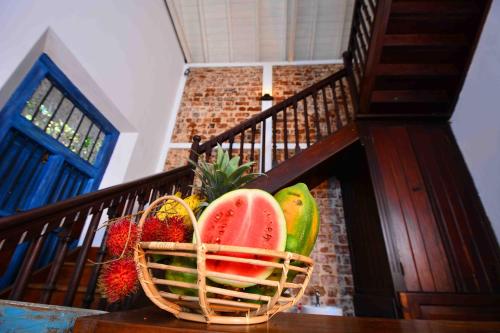 a basket of fruit sitting on a stair case at Handun Villas in Talalla