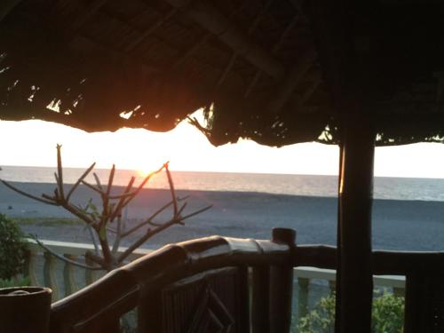 a view of the ocean from a resort balcony at Seabreeze Beachfront Home and Cottages new management in San Juan