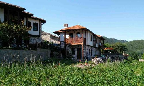 a house with a balcony on the side of it at Semana Guesthouse in Vrata