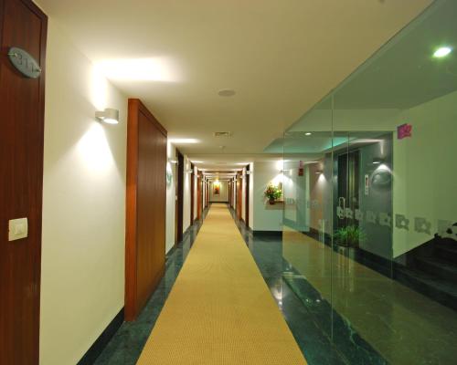 a hallway with a yellow walkway in a building at Park Ornate Hotel in Pune