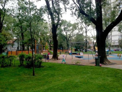a park with a playground with children playing in it at Architectural City Loft in Sofia
