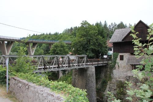 a bridge over a river with a train on it at Apartment Snježana in Slunj