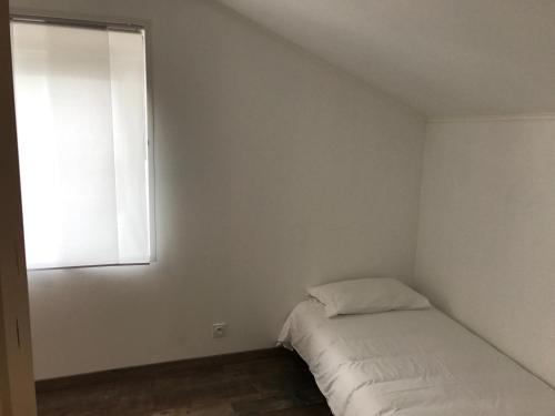a small bedroom with a bed and a window at L'hostellerie de Sèvremont in Saint-Michel-Mont-Mercure