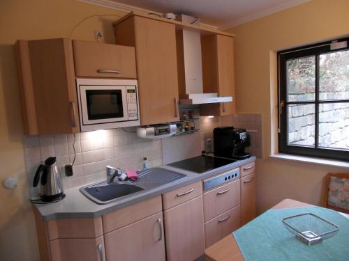 una cucina con lavandino e forno a microonde di Haus Ferienromantik a Pirna