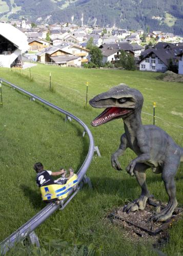 a statue of a dinosaur in a roller coaster at Aparthotel Fernblick in Fiss