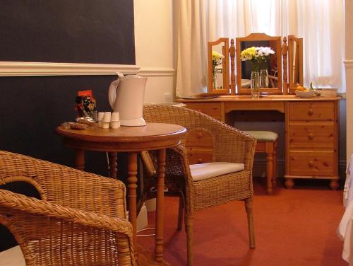 a room with a table and chairs and a desk at The Dales in Harrogate
