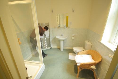 a person taking a picture of a bathroom at The Dales in Harrogate