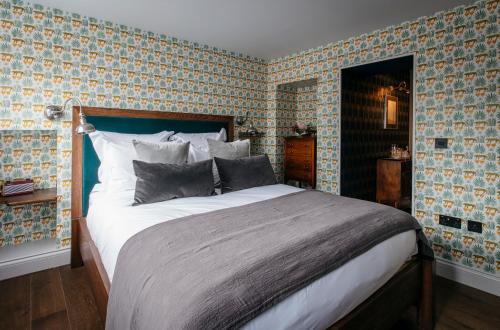 a bedroom with a large bed in a room at The Bower House, Restaurant & Rooms in Shipston on Stour
