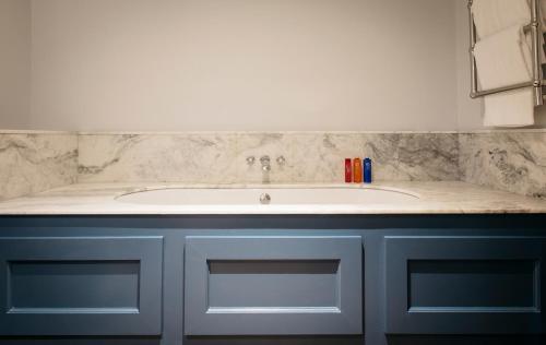 a bathroom with a sink and a counter at The Bower House, Restaurant & Rooms in Shipston on Stour