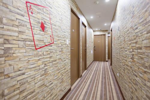 a hallway with a stone wall with a basketball sign on it at A Ace Hotel in Taichung
