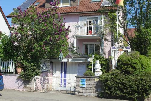 a white house with a statue in front of it at Lila Villa Schwenningen in Villingen-Schwenningen